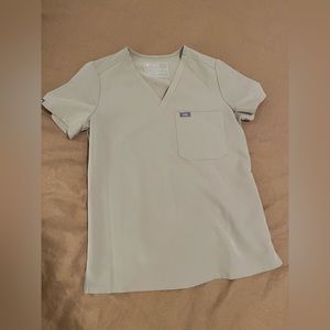 Figs brand, size XS, short sleeve one pocket scrub top in tan.